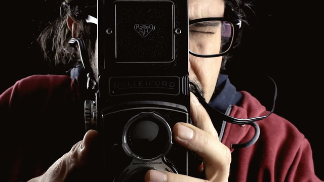 Man vintage paparazzi shooting photographs