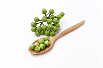 Pea eggplant on wooden spoon with space on white background