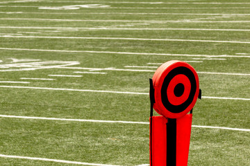 Football field and orange and black 10 yards chain