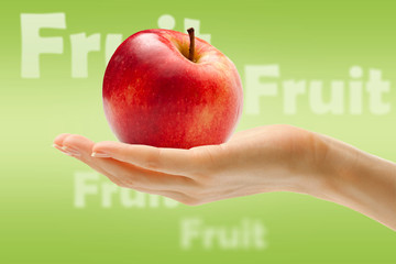 Female hand with red apple