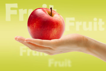 Female hand with red apple