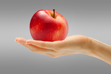 Female hand with red apple