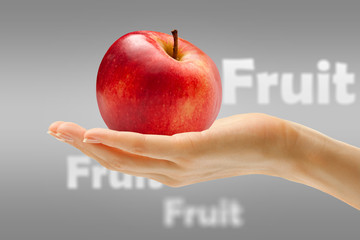 Female hand with red apple