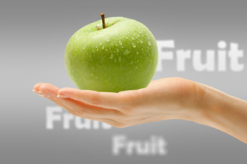 Female hand with green apple