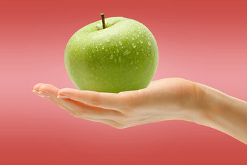 Female hand with green apple