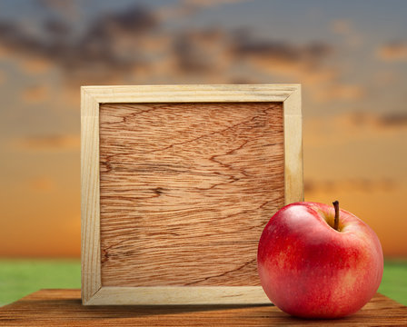 Red apple with wooden frame