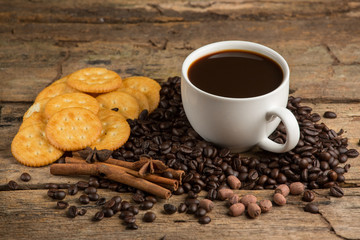 Cup of coffee on a wooden board and biscuits