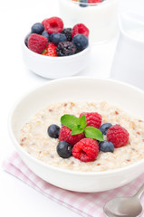 healthy breakfast - oatmeal with fresh berries isolated on white