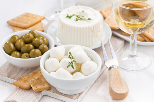 fresh soft cheeses, crackers and pickles to wine, close-up
