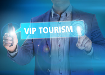 Businessman presses button vip tourism on virtual screens. Busin