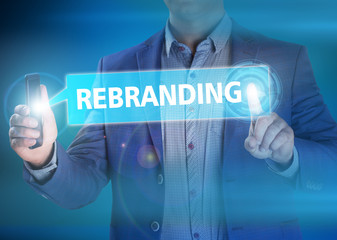 Businessman presses button rebranding on virtual screens. Busine