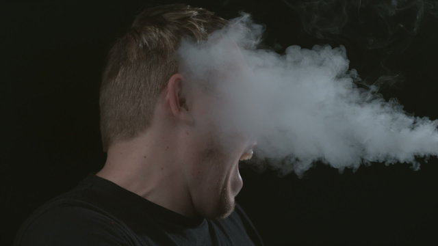 Smoke Blowing In Mans Face- Slow Motion