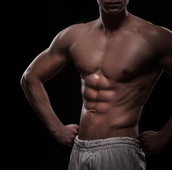 Fototapeta premium athletic man torso over black