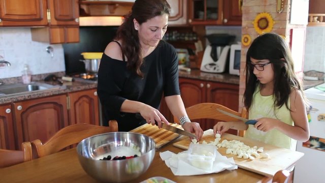 Woman Preparing Food With Her Daughter