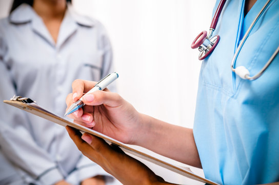 surgeon writing patient’s record after examine health