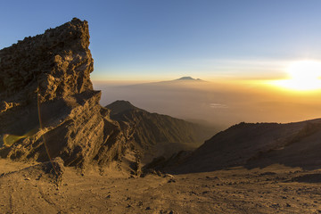 Sunrise on Mount Meru with Mt Kilimanjaro in the distance, near Arusha in Tanzania. Africa.