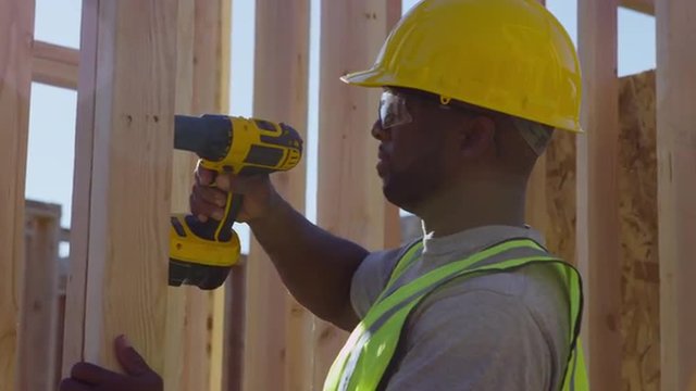 Construction worker using drill