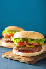 burger with beef patty lettuce onion tomato ketchup