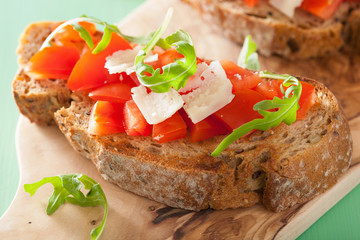 italian bruschetta with tomatoes parmesan rucola