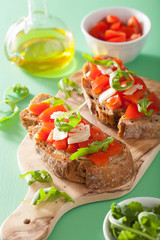 italian bruschetta with tomatoes parmesan rucola