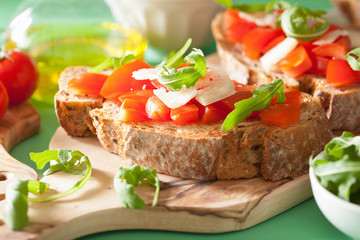 italian bruschetta with tomatoes parmesan rucola