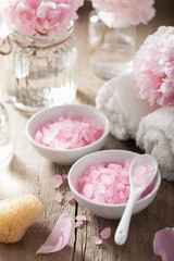 Obraz na płótnie Canvas spa set with peony flowers and pink herbal salt