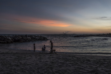 Silhouette  happy family  enjoy running on the sunset beach, Thailand. 