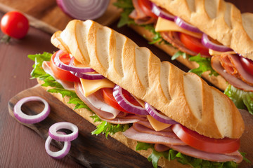 long baguette sandwich with ham cheese tomato lettuce