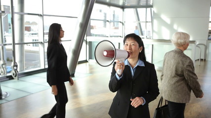 Businesswoman yells through megaphone - Powered by Adobe