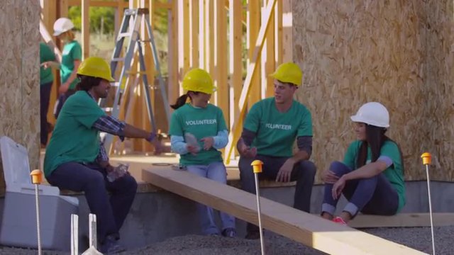 Volunteers take break at construction site