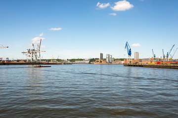 Motor barge on the river Elbe in the harbour of Hamburg. In the background the new skyline with the...