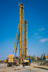 Pile driving machine in construction site