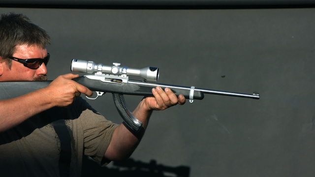 Man shooting semi-automatic gun, slow motion