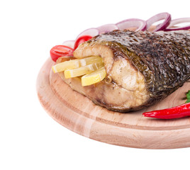 Fried carp tail with lemon and onion.