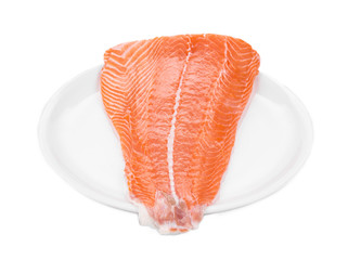 Raw salmon fillet on plate.