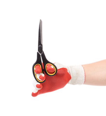 Hand in yellow glove holding scissors.
