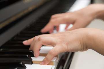 Fototapeta premium Close up of woman hands playing piano