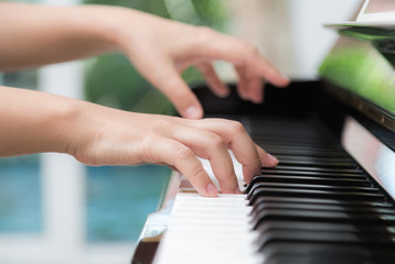 Fototapeta premium Close up of woman hands playing piano