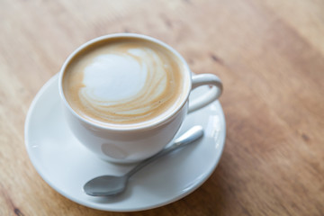 Coffee in white cup on wood table