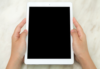 Woman hand touch white tablet with blank empty screen