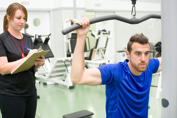 personal trainer and man in gym