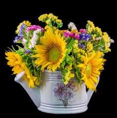 Yellow sunflowers and colored wild flowers, white watercan