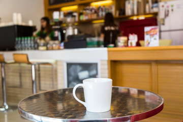 Coffee cup on table in cafe