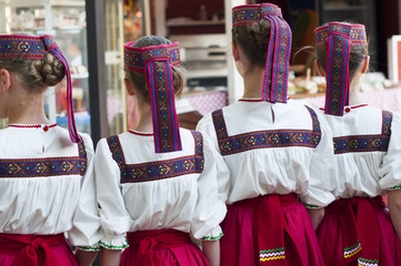 Girls in Slavonic national costumes  preparing for a dance performance.