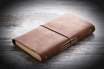 hand made leather notebook over wooden vintage background
