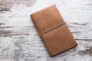 hand made leather notebook over wooden vintage background