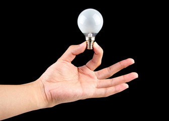 Holding light bulb with black background