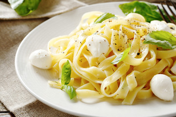 Pasta with cheese and basil on a plate