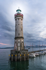 Mysterious lighthouse at evening in harbor of Lindau in lake Con