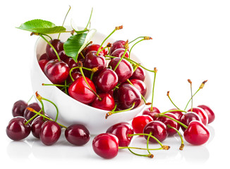 fresh cherry berries with green leaf isolated on white